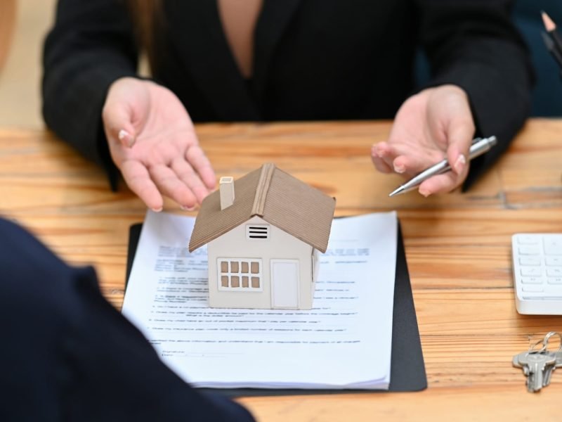 Real estate agent or financial advisor consulting with client for real estate investment.